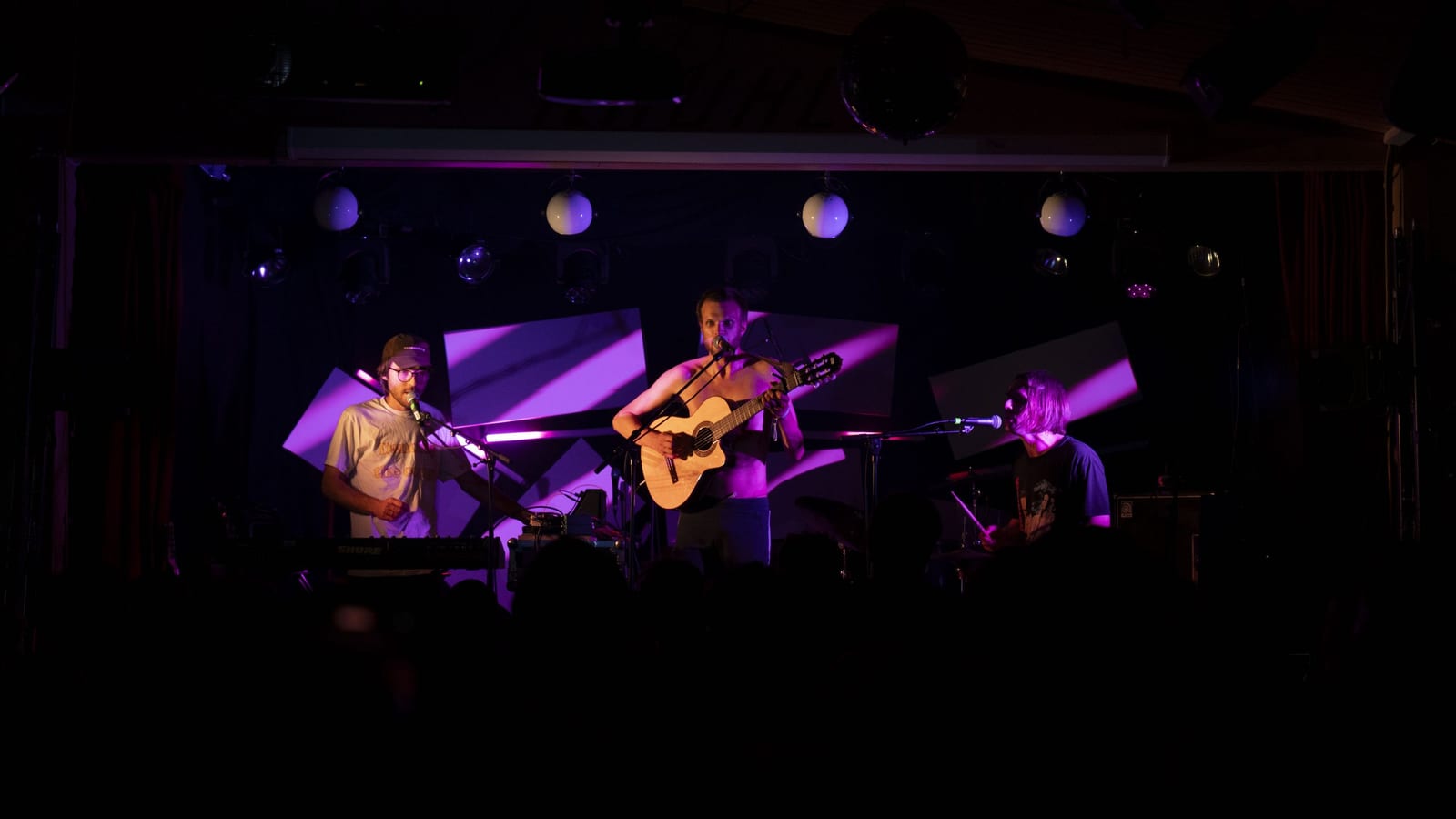 A band performing on stage at Indiefjord, lit by purple stage lights.